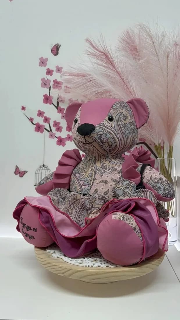 Una osita del recuerdo de Tonitu, de tela rosa estampada y falda de volantes